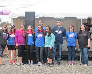 Neighbors | Zack Shively.The Volunteer Committee for the event Making Strides Against Breast Cancer of Tri-County at Austintown Fitch on Oct. 7 organized the walk and included a photo booth, dance area, memory board, raffles and food trucks for the event. Pictured are, from left, Danielle Procopio, Jayne Caputo, Gina Nocera, Caty Baker, Jessie, Marissa Cullen, Pam Wray, Randy Martin, chairperson Kathy Hoffman, Tess Spincic and Kelly Stevens of HOT 101 on the stage. Volunteers not pictured are Marie Cullen and Dave Sisk.