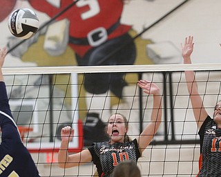 United's Camryn Jarrett (7) spikes the ball over Springfield's Ellie Centofanti (10) and Springfield's Zoe Renaldy (11) during the first set as United Local High School takes on Springfield Local High School during the 2017 DIII District Volleyball Tournament, Thursday, Oct. 19, 2017, at Salem High School in Salem...(Nikos Frazier | The Vindicator)..