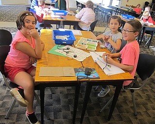 Neighbors | Zack Shively.Children worked on creating Lego robots at the Austintown library on Oct. 13 as a part of the Lego WeDo program at the library. The children worked together to build their robot creation.