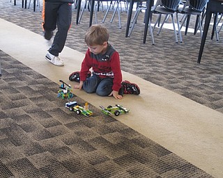 Neighbors | Zack Shively.The Lego WeDo Robots program allowed children to use their minds to add different elements to the program. Some children replaced parts to their robot to see how it would run. Some children changed the programming for the machine to see if they could increase the speed of the machine. Pictured, one of the groups added wheels and a second trailer to see how well their machine pulled the objects.