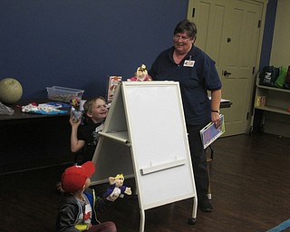 Neighbors | Zack Shively.The first story at Boardman Library's A Box of Books event, "Falling for Rapunzel," took the tale of Rapunzel and gave it a twist. Pictured is Christopher as Repunzel getting ready to throw an object over the whiteboard.