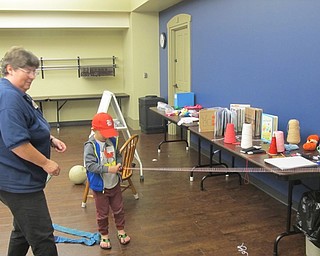 Neighbors | Zack Shively.The children made crafts at A Box of Books at the Boardman library. They all made a treasure box, fishing line or a Rapunzel braid. Pictured is librarian Karen Saunders helping Peyton make a fishing line.