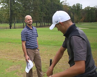 Jimmy Graham, a junior at Warren JFK, and golf coach Heath Myers talk on the driving range, Monday, Oct. 9, 2017, at the Avalon Golf and Country Club in Howland. ..(Nikos Frazier | The Vindicator)..