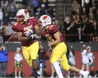 Cardinal Mooney quarterback Antonio Page (15) hands off to Cardinal Mooney fullback Andre McCoy (6) during the first quarter as Ursuline High School takes on Cardinal Mooney High School, Friday, Oct. 20, 2017, at Stambaugh Stadium at Youngstown State University in Youngstown...(Nikos Frazier | The Vindicator)..