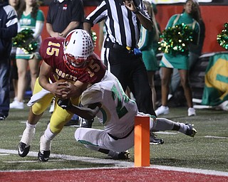 Cardinal Mooney quarterback Antonio Page (15) runs into the endzone for a touchdown as he is tackled by Ursuline wide receiver Robbie Sullivan (24) during the second quarter as Ursuline High School takes on Cardinal Mooney High School, Friday, Oct. 20, 2017, at Stambaugh Stadium at Youngstown State University in Youngstown...(Nikos Frazier | The Vindicator)..