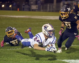 ROBERT K.YOSAY | THE VINDICATOR..Western Reserve at McDonald week 9..#24 Western Reserve Kade Hiles leaps for the first down after being tackled by McDonald 21 Cameron Tucker as #31 Alex Cintron looks on.. This set up Wester Reserve 3rd quarter TD