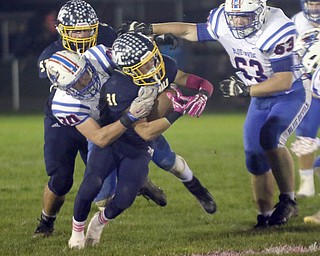 ROBERT K.YOSAY | THE VINDICATOR..Western Reserve at McDonald week 9..McDonald #31 Alex Cintron gets stopped at the line by Western Reserve #30 Ryan Slaven as McDonald#57 Calvin Wolford and Western Reserve