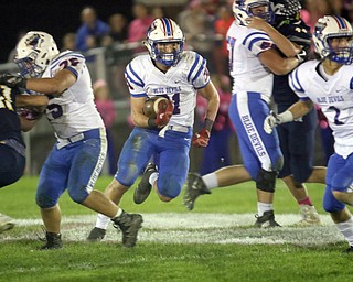 ROBERT K.YOSAY | THE VINDICATOR..Western Reserve at McDonald week 9.Western Reserve #31  Adam  Gatrell finds a whole as.#75 Marcos Cruz and #57 Cody Hladun open the whole.. watching the defense #2 Todd Henning during second quarter action