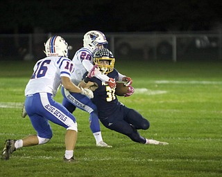 ROBERT K.YOSAY | THE VINDICATOR..Western Reserve at McDonald week 9.McDonald #31  Alex Cintron gets caught in the backfield by Western Reserve #28 Aaron Posten and #16 - not listed-  as he is caught for a loss during first half action