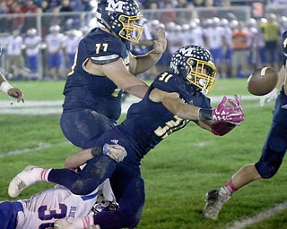ROBERT K.YOSAY | THE VINDICATOR..Western Reserve at McDonald week 9..McDonald #31 Alex Cintron bobbles and looses the ball during second quarter action behind him is #77 Nate Dean Western Reserve #30  Ryan Slaven was tackling