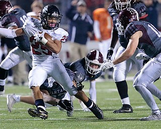 BOARDMAN, OHIO - OCTOBER 20, 2017:   Austintown's Randolph Smith Jr. (25) eyes Boardman's Dom Stilliana (18) as he breaks the tackle of Boardman's Connor Miller (33) during the 3rd qtr. at Spartan Stadium. MICHAEL G TAYLOR | THE VINDICATOR