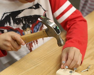 Chanyeol Hutchens(7) of Wilksburough, N.C., hammer in a nail while building a wooden hedgehog, Saturday, Oct. 21, 2017, at OH WOW! in Youngstown...(Nikos Frazier | The Vindicator)