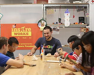 Doug Rutana, Volunteer Coordinator, watches as kids build wooden hedgehogs, Saturday, Oct. 21, 2017, at OH WOW! in Youngstown...(Nikos Frazier | The Vindicator)
