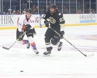 Youngstown Phantoms defenseman Steve Holtz (24) and Muskegon Lumberjacks forward Egor Afanasyev (23) skate towards the puck during the first period as the Muskegon Lumberjacks take on the Youngstown Phantoms, Saturday, Oct. 21, 2017, at the Covelli Centre in Youngstown...(Nikos Frazier | The Vindicator)..