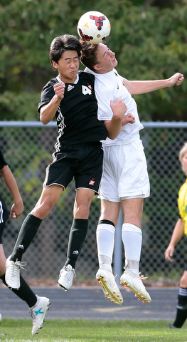 BOARDMAN, OHIO - OCTOBER 21, 2017:  Mooney's Mark Armile (4) and Howland's Francis Cesta (3) battle for the ball during the 1st half at Howland. MICHAEL G TAYLOR | THE VINDICATOR