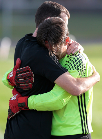 BOARDMAN, OHIO - OCTOBER 21, 2017:  Mooney's senior Kenny Bledsoe (0) GK and Mooney's coach Chris Sekman hug after Mooney's  loss to Howland Tigers at Howland. MICHAEL G TAYLOR | THE VINDICATOR