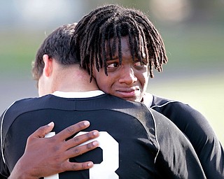 BOARDMAN, OHIO - OCTOBER 21, 2017:  Mooney's senior Kenny Bledsoe (7) and Mooney's Nick Jadue (13) hug after their loss to Howland Tigers at Howland. MICHAEL G TAYLOR | THE VINDICATOR