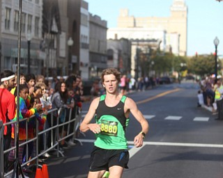 Ryan Roush(8880) crosses the finish line to place second with a time of 30:16 during the 42nd annual Youngstown Peace Race, Sunday, Oct. 22, 2017, in Youngstown...(Nikos Frazier | The Vindicator)