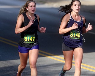 Amy Isoldi(8147) and twin Ashley Isoldi(8148) both of Girard run down Mahoning Ave towards downtown during the 42nd annual Youngstown Peace Race, Sunday, Oct. 22, 2017, in Youngstown. Amy ran a 51:28, and Ashley 51:27...(Nikos Frazier | The Vindicator)
