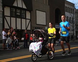 Stephen, Abbie and daughter Poppy(1) Zubyk run down W. Federal St. towards the finish line during the 42nd annual Youngstown Peace Race, Sunday, Oct. 22, 2017, in Youngstown...(Nikos Frazier | The Vindicator)