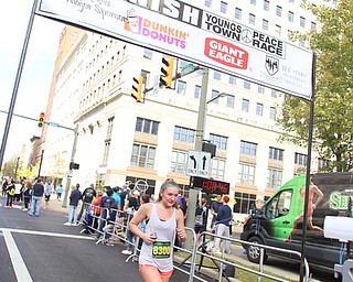 Lilan Miller(8300) of Silver Spring, MD crosses the finish line during the 42nd annual Youngstown Peace Race, Sunday, Oct. 22, 2017, in Youngstown...(Nikos Frazier | The Vindicator)