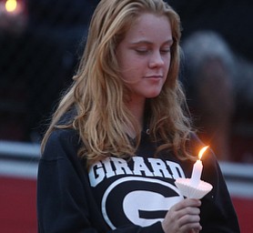 Viola McClimans(14) holds a candle during a vigil for Girard Police Officer Justin Leo, Sunday, Oct. 22, 2017, at Arrowhead Stadium in Girard. Officer Leo was killed while responding to a potential suicide around 10:00 p.m., Saturday, Oct. 21, 2017, on the 400 block of Indiana Ave in Girard. Officer Leo was transported to St. ElizabethÕs Youngstown for surgery where he later died. ..(Nikos Frazier | The Vindicator)