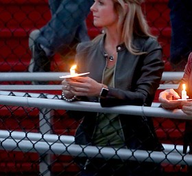 Rachel Leatherberry holds a candle during a vigil for Girard Police Officer Justin Leo, Sunday, Oct. 22, 2017, at Arrowhead Stadium in Girard. Officer Leo was killed while responding to a potential suicide around 10:00 p.m., Saturday, Oct. 21, 2017, on the 400 block of Indiana Ave in Girard. Officer Leo was transported to St. ElizabethÕs Youngstown for surgery where he later died. ..(Nikos Frazier | The Vindicator)