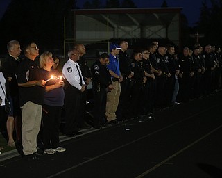 David and Pat Leo stand with candles during a vigil for their son, Girard Police Officer Justin Leo, along with members of the Girard Police Department and surrounding Police agencies, Sunday, Oct. 22, 2017, at Arrowhead Stadium in Girard. Officer Leo was killed while responding to a potential suicide around 10:00 p.m., Saturday, Oct. 21, 2017, on the 400 block of Indiana Ave in Girard. Officer Leo was transported to St. ElizabethÕs Youngstown for surgery where he later died. ..(Nikos Frazier | The Vindicator)