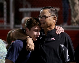 David Leo comforts a member of the Girard Golf Team after vigil for his son, Girard Police Officer Justin Leo, Sunday, Oct. 22, 2017, at Arrowhead Stadium in Girard. Officer Leo was killed while responding to a potential suicide around 10:00 p.m., Saturday, Oct. 21, 2017, on the 400 block of Indiana Ave in Girard. Officer Leo was transported to St. ElizabethÕs Youngstown for surgery where he later died. ..(Nikos Frazier | The Vindicator)