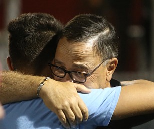 David Leo comforts a member of the Girard Golf Team after a vigil for his son, Girard Police Officer Justin Leo, Sunday, Oct. 22, 2017, at Arrowhead Stadium in Girard. Officer Leo was killed while responding to a potential suicide around 10:00 p.m., Saturday, Oct. 21, 2017, on the 400 block of Indiana Ave in Girard. Officer Leo was transported to St. ElizabethÕs Youngstown for surgery where he later died. ..(Nikos Frazier | The Vindicator)