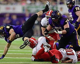 CEDAN FALLS, IOWA - OCTOBER 21, 2017: Northern Iowa's Marcus Weymiller, left, flies through he air after having his legs taken out by Youngstown State's Lee Wright and Kyle Hegedus during the first half of their game Saturday afternoon at the UNI Dome. Northern Iowa won 19-14. DAVID DERMER | THE VINDICATOR