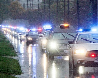 William D. Lewis The Vindicator Police escort/motorcade escorting body of slain Girard PD office Justin Leo makes its way up Churchill Rd. in girard Monday afternoon. The body was being transported to Blackstoine Funeral home after an autopsy in Cuyahoga county.
