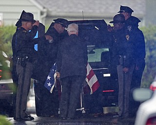 GIRARD, OHIO - OCTOBER 23, 2017: The casket for Officer Justin Leo is removed from the hearse while officers from the Girard Police Department, Ohio High Way State Patrol as well, as others salute, outside of Blackstone Funeral Home, Monday afternoon. DAVID DERMER | THE VINDICATOR