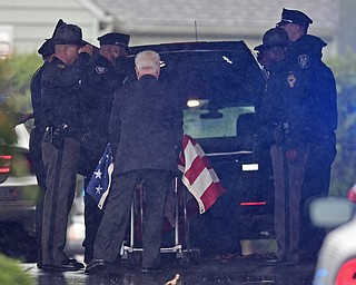 GIRARD, OHIO - OCTOBER 23, 2017: The casket for Officer Justin Leo is removed from the hearse while officers from the Girard Police Department, Ohio High Way State Patrol as well, as others, salute outside of Blackstone Funeral Home, Monday afternoon. DAVID DERMER | THE VINDICATOR