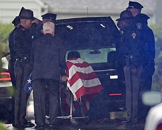 GIRARD, OHIO - OCTOBER 23, 2017: The casket for Officer Justin Leo is removed from the hearse while officers from the Girard Police Department, Ohio High Way State Patrol as well, as others, salute outside of Blackstone Funeral Home, Monday afternoon. DAVID DERMER | THE VINDICATOR
