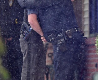 GIRARD, OHIO - OCTOBER 23, 2017: A Girard Police officer gets a hug from a Ohio Highway Patrol Officer after the casket for Officer Justin Leo was moved into Blackstone Funeral Home, Monday afternoon. DAVID DERMER | THE VINDICATOR