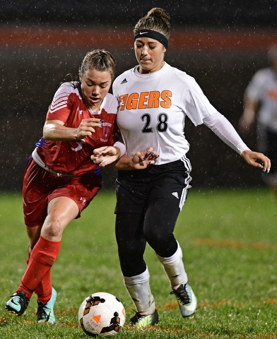 NEW SPRINGFIELD, OHIO - OCTOBER 23, 2017: Lordstown's Lexie Ensign, left, and Springfield's Shantel Springer battle for the Baltimore during the first half of their game Monday night at Springfield High School. Springfield won 5-1. DAVID DERMER | THE VINDICATOR