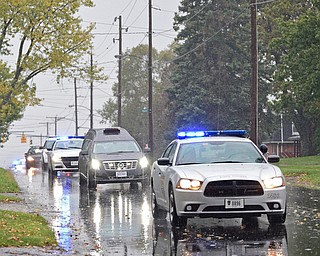 GIRARD, OHIO - OCTOBER 23, 2017: The Hearse carrying the casket for Officer Justin Leo drives down Churchill Road in the motorcade as it makes it way to Blackstone Funeral Home, Monday afternoon. DAVID DERMER | THE VINDICATOR
