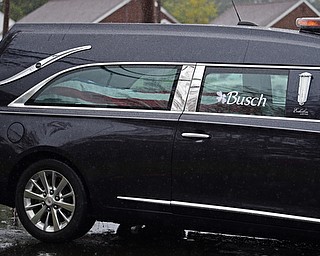 GIRARD, OHIO - OCTOBER 23, 2017: The Hearse carrying the casket for Officer Justin Leo drives down Churchill Road in the motorcade as it makes it way to Blackstone Funeral Home, Monday afternoon. DAVID DERMER | THE VINDICATOR