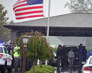GIRARD, OHIO - OCTOBER 23, 2017: The casket for Officer Justin Leo is removed from the hearse while officers from the Girard Police Department, Ohio High Way State Patrol as well, as others salute, outside of Blackstone Funeral Home, Monday afternoon. DAVID DERMER | THE VINDICATOR