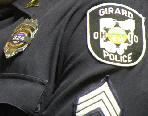 William D. Lewis The Vindicator Girard PD officers wore black bunting and slain officer Leo's badge # during 10-24-17 prayer vigil.