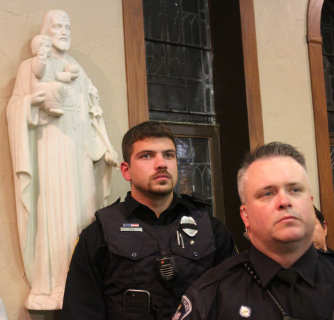 William D. Lewis The Vindicator Officers from many area departments attended 10-24-17 prayer vigil for salin GPD officer Justin Leo at St rose Church Adam rios of Bazetta Pd, left, and Chad McGary of Liberty..