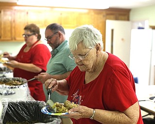 Smith Corners United Methodist Church, 3000 S. Canfield-Niles Road, Austintown, hosts a free Supper at the Corner as a monthly community outreach. Donations are accepted to continue the program. Above, volunteers for last week’s event fill plates with food. See video at vindy.com.