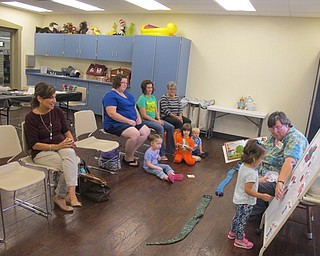 Neighbors | Zack Shively  .Children listened and interacted during a reading of “Ten Red Apples“ by Pat Hutchins during the Tales and Talk for 2s and 3s at the Boardman library on Sept. 13.