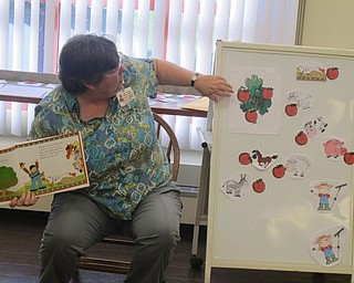 Neighbors | Zack Shively  .Boardman librarian Karen Saunders read “Ten Red Apples“ by Pat Hutchins and had the children bring up magnets with animals and apples to the board.