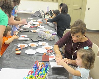 Neighbors | Zack Shively  .Children decorated booklets during craft time at Tales and Talk for 2s and 3s. The event happened at Boardman library and included time for stories and crafting.