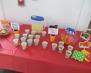 Neighbors | Zack Shively  .Librarians at the Poland library set out snacks and drinks for children during their event on Sept. 14.