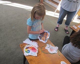 Neighbors | Zack Shively.A child laced around a picture of Brown Bear from Bill Martin, Jr.'s "Brown Bear, Brown Bear, What Do You See?" at the Poland library at their 50th anniversary celebration of the book on Sept. 14.