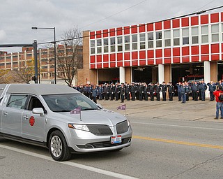     ROBERT K. YOSAY  | THE VINDICATOR..The hearse with the casket of Bat Chief.. Russo Passes in front of Fire Station Number 1..Funeral Services for YFD  Battalion Chief Ron Russo were held Thursday at  Poland United Methodist Church ..The funeral procession then went from PUM to Fire Station  #1 and then to Green Haven  .Russo, 64, was a member of the city fire department for 37 years, working the rescue squad for the majority of his career...-30-