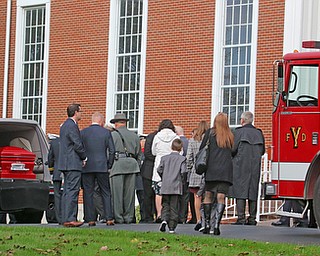     ROBERT K. YOSAY  | THE VINDICATOR..The casket carrying the body of Battalion Chief  as family members  and honor guard nearby..Funeral Services for YFD  Battalion Chief Ron Russo were held Thursday at  Poland United Methodist Church ..The funeral procession then went from PUM to Fire Station  #1 and then to Green Haven  .Russo, 64, was a member of the city fire department for 37 years, working the rescue squad for the majority of his career...-30-